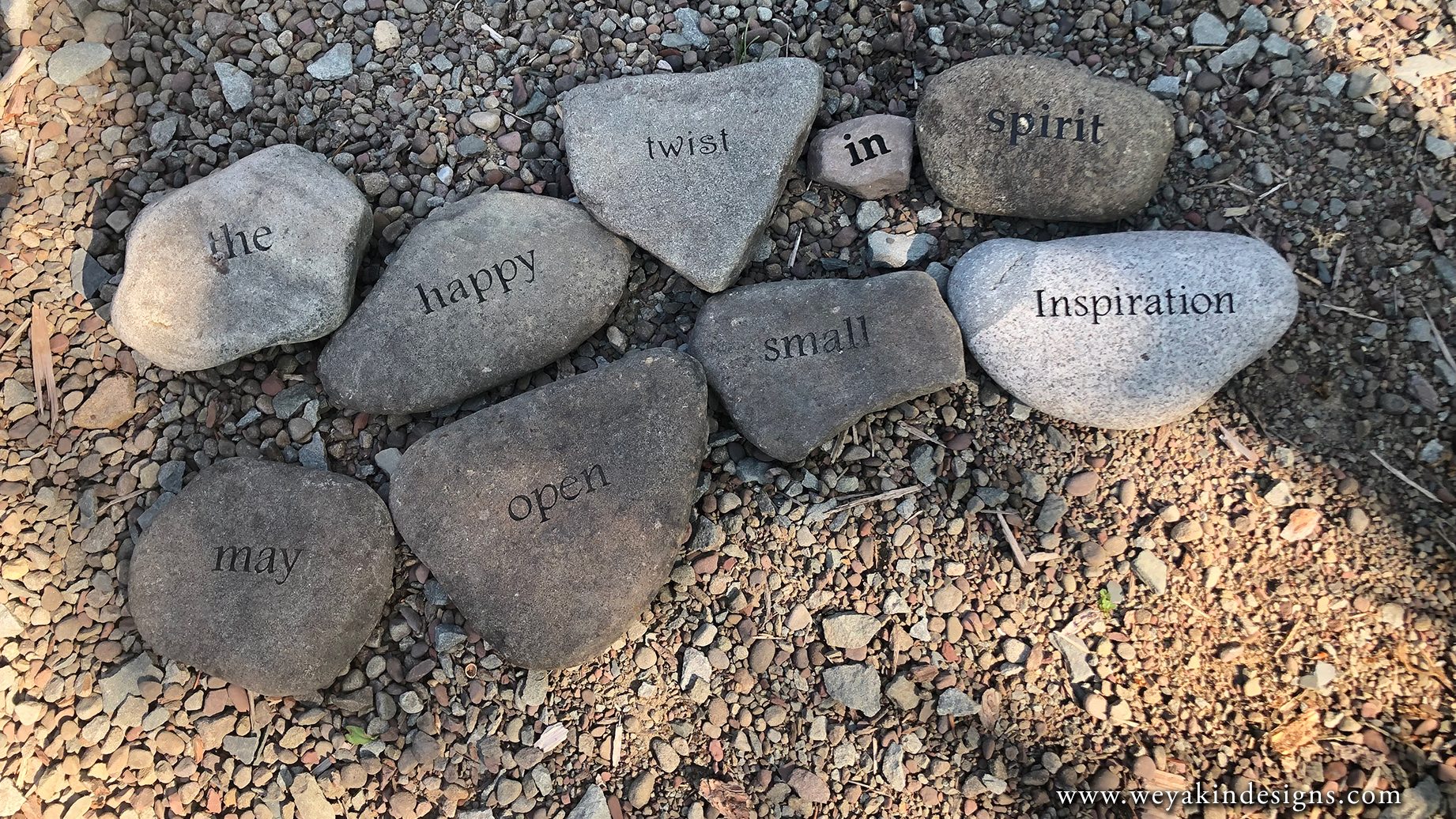 Stones on the ground that read, "the happy twist in spirit may open small inspiration" in the Word Garden at The Highlights Foundation. Poem and photo by Victoria K. Chapman.