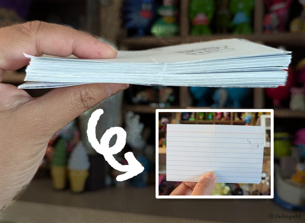 A stack of index cards in Shiho's hands showing how she uses them to draw thumbnail images.